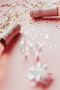 Low section of woman with pink petals on floor