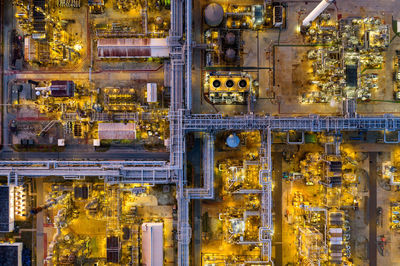 Aerial view of illuminated factory in city