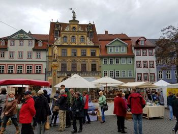 People at town square against buildings