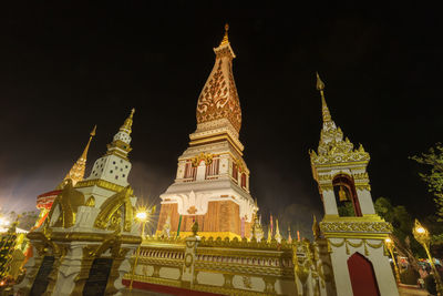 Low angle view of illuminated temple building against sky at night