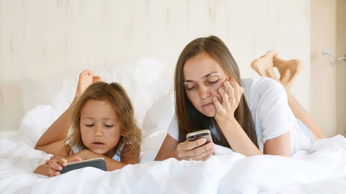 Women lying down on bed at home