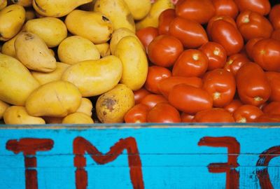Full frame shot of tomatoes and potatoes at market stall