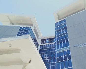 Low angle view of office building against sky