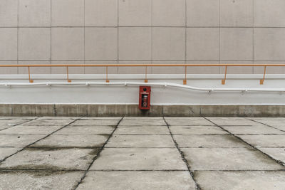 Fire hose on retaining wall against building