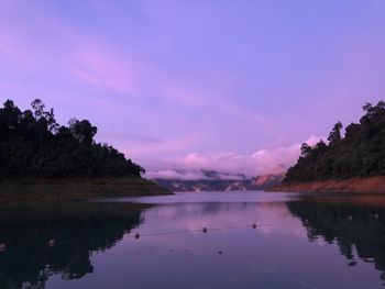 Scenic view of lake against sky at sunset