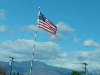 Low angle view of flag against sky