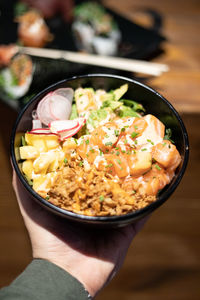 High angle view of sushi bowl in hand