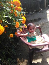 Portrait of smiling girl sitting in yard