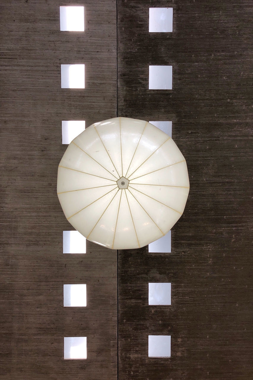 LOW ANGLE VIEW OF ILLUMINATED ELECTRIC LAMP HANGING ON WALL