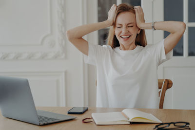 Young woman using laptop at office