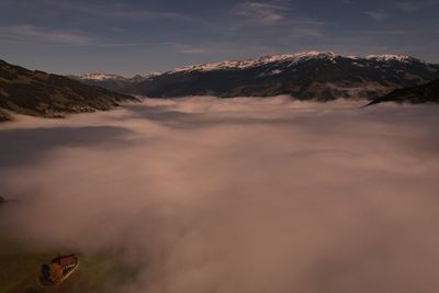 Scenic view of mountain with hut and sky