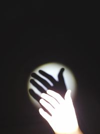 Close-up of hand holding illuminated lamp