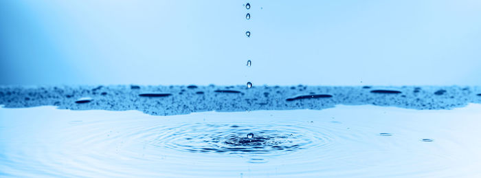 Close-up of splashing water against blue sky