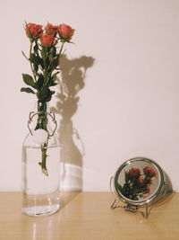 Close-up of roses in vase on table