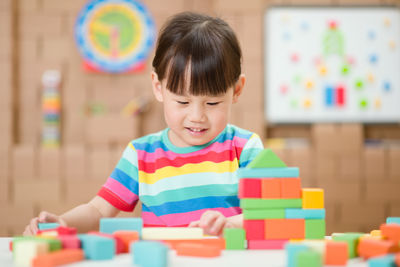 Cute girl playing with toy at home