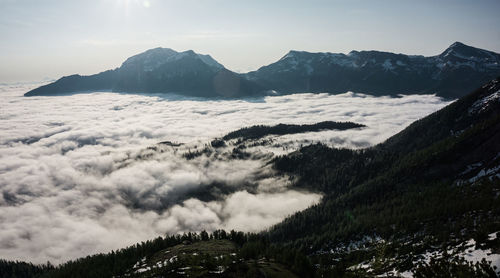 Scenic view of land and mountains against sky