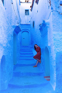 Woman with orange dress in chefchaouen ii