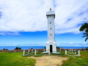 Scenic view of lighthouse by sea against sky
