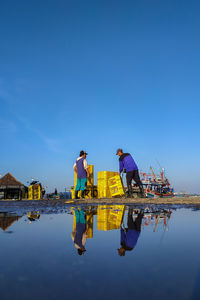 Manual workers working at beach