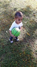 High angle view of boy playing with ball