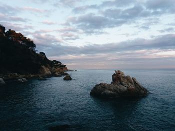 Rock formations in sea against sky