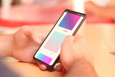 Close-up of hand holding mobile phone