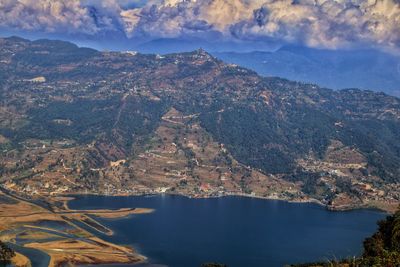 High angle view of sea and mountains against sky