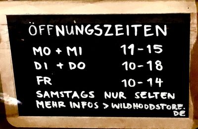 Close-up of information sign on wall