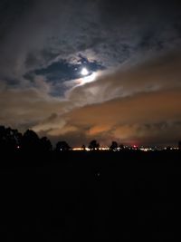 Illuminated city against sky at night