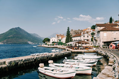 Houses by sea against clear sky