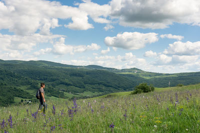 Adult man on hiking on the hills relaxing in nature