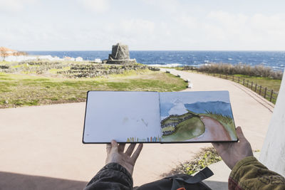 Hands of woman with painting at corvo island