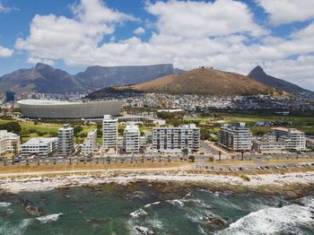 Scenic view of buildings and mountains against sky