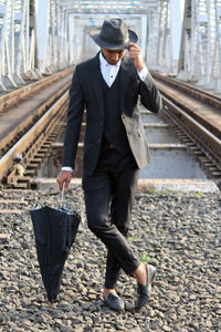 Full length of man walking on railroad track