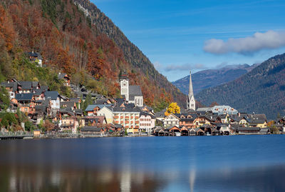 Townscape by lake against sky in town