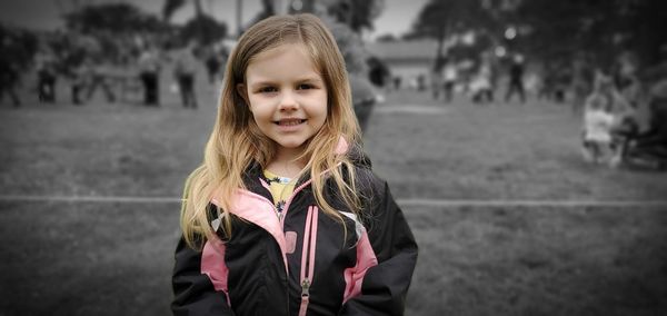 Portrait of smiling girl standing outdoors