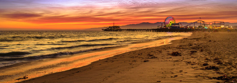 Scenic view of beach against sky during sunset