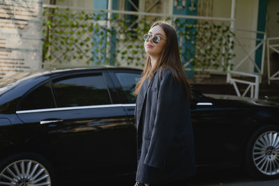 Portrait of young woman in car