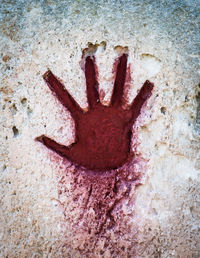 Close-up of human hand on wall