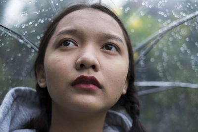 Close-up portrait of woman in rain