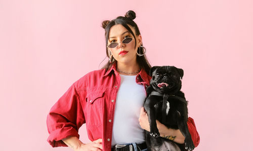 Young woman with dog against white background