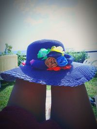 Midsection of woman wearing hat against plants