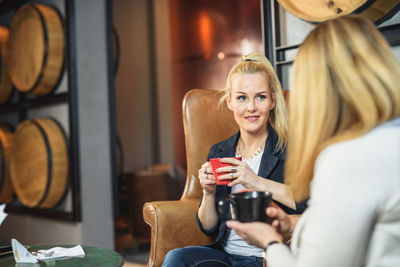 Adult woman talking with friend in cafeteria