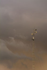 Low angle view of telephone pole against sky