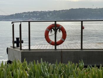 View of railing by sea against sky