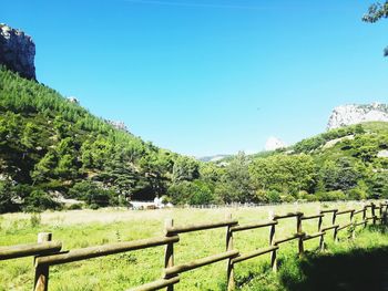 Scenic view of mountains against clear blue sky