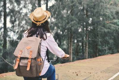 Rear view of woman on bicycle