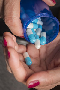 High angle view of hands holding multi colored woman