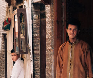 Portrait of young man standing at home