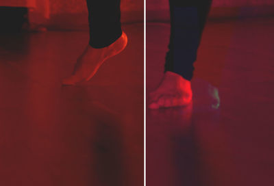 Low section of person standing on red floor